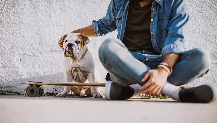 Skater resting with his dog