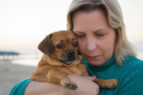 Woman with her dog during a sunset.