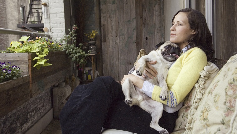 Woman sitting with small dog