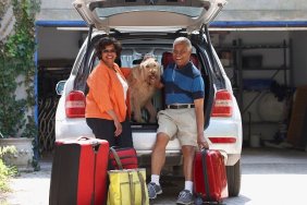 Black couple loading car for vacation