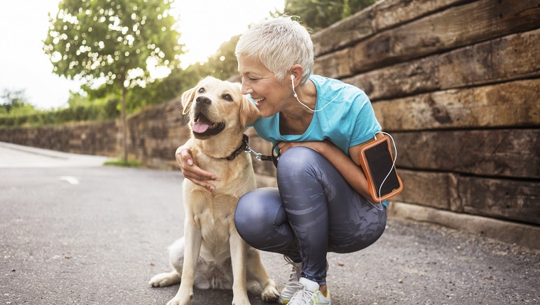 Mature woman jogging with her dog