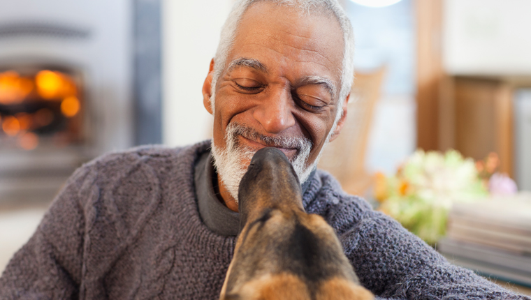 man smiling at dog