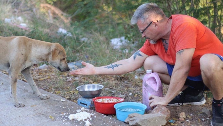 Michael feeding a dog in Thailand