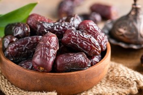 Dried medjool dates in wooden bowl. Islamic culture, Ramadan holiday concept