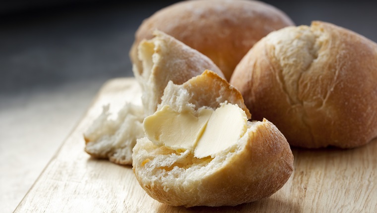 Buttered bread roll.  Lovely and crusty, ready to eat.