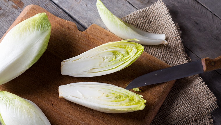 Top view on endive lying on wooden background.