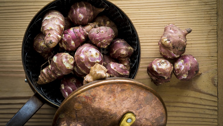 Jerusalem artichokes in a saucepan.