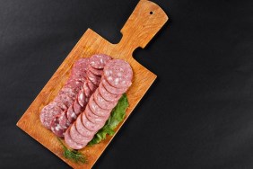 saveloy sausage slices on cutting board topview