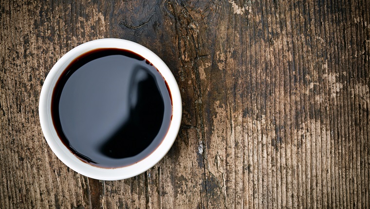 Bowl of Balsamic vinegar on wooden table