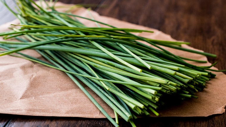 Fresh Chives / Siniklav or Frenk Sogani on wooden surface. Organic Concept.