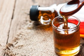 maple syrup in glass bottle on wooden table