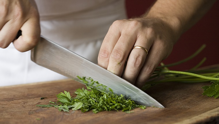 Chef chopping parsley