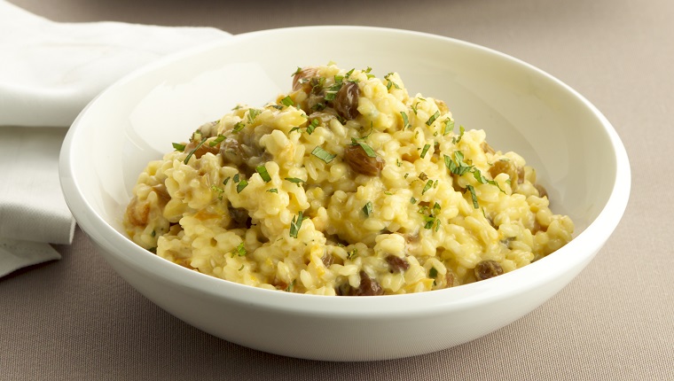 Rissotto in bowl with chicken and parsley