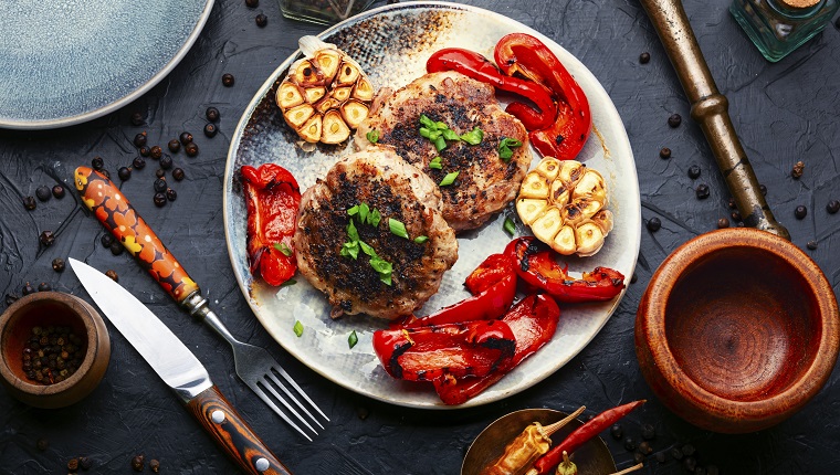 Fried beef steak or rissole with minced meat and roasted bell pepper and garlic