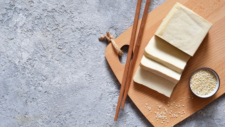 Classic tofu cheese on a wooden board. Soy cheese. View from above.