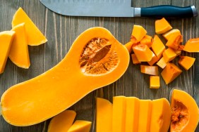 Butternut squash on a rustic wooden surface.