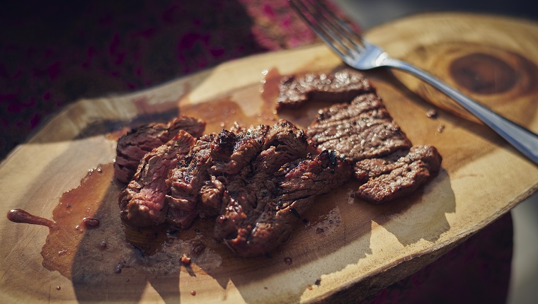 Close up of grilled tender meat in juices