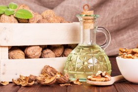 Walnut oil and nuts in a box on a background of burlap