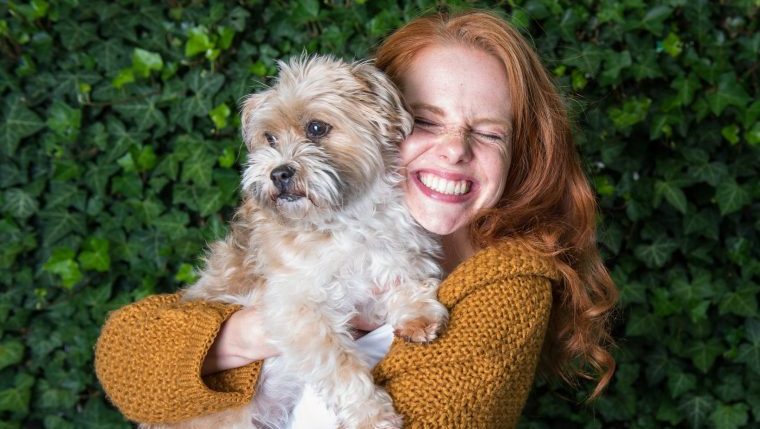 woman hugs dog why the Wall Street Journal is wrong about dogs