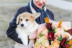 woman with dog and dog-safe flowers for mother's day