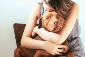 sad woman hugging dog why people surrender dogs