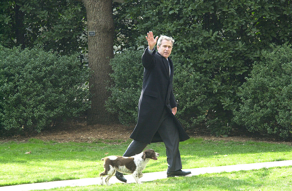 President George W. Bush and his dog Spot walking towards the Oval Office of the White House.