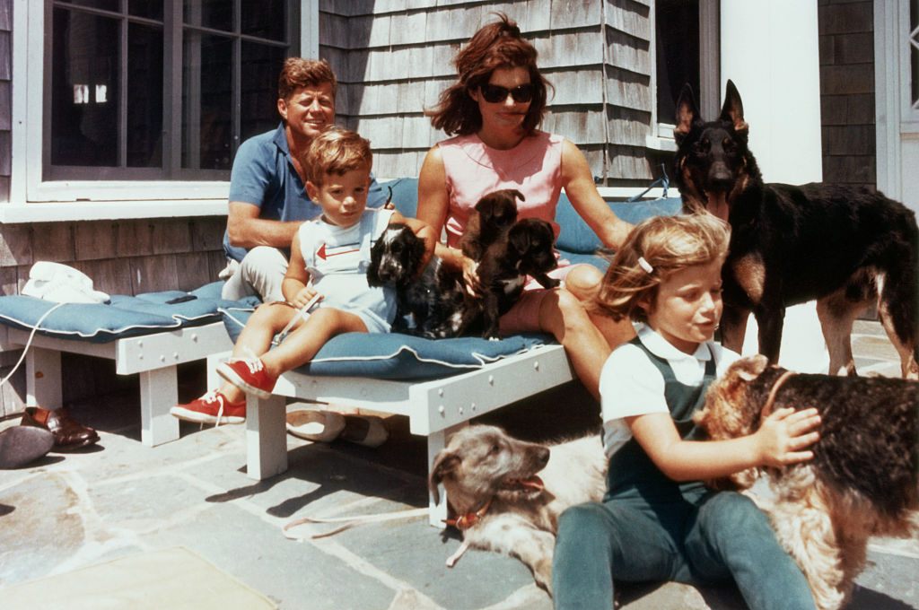 The first family on the patio of their Squaw Island House in Hyannisport, Massachusetts, with several puppies and dogs.