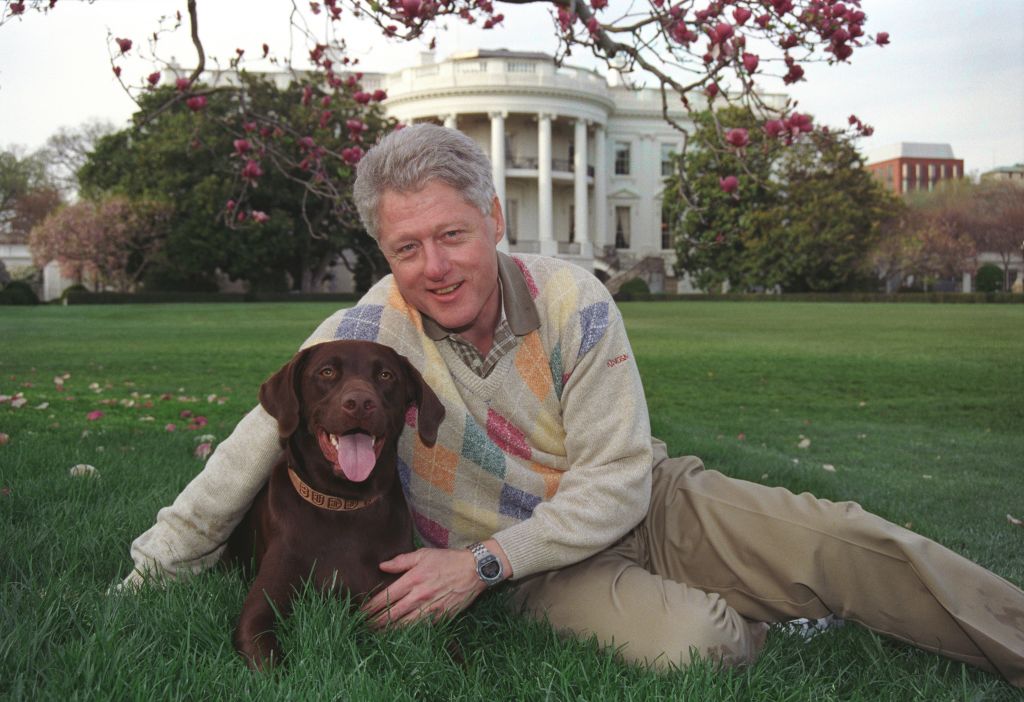 President William Jefferson Clinton posing with Buddy the Dog outside of the White House, April 6, 1999