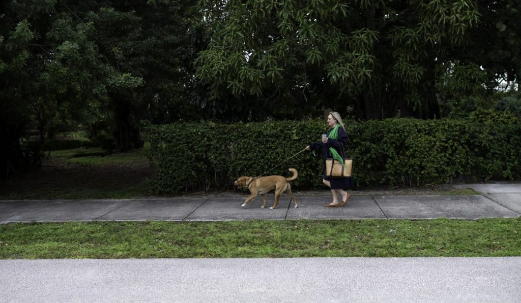 Woman walking her leashed dog on the side walk, a Chicago police officer shot a dog who broke loose from their leash