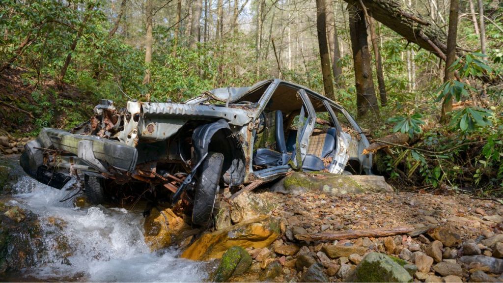 Remains of a car beside a mountain stream, which apparently fell from a dirt road up the mountain, in Unicoi County, Tennessee.