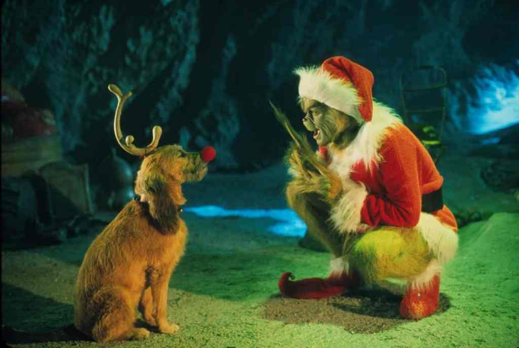 The Grinch played by Jim Carrey conspiring with his dog Max against the Whos in the movie “How the Grinch Stole Christmas.”