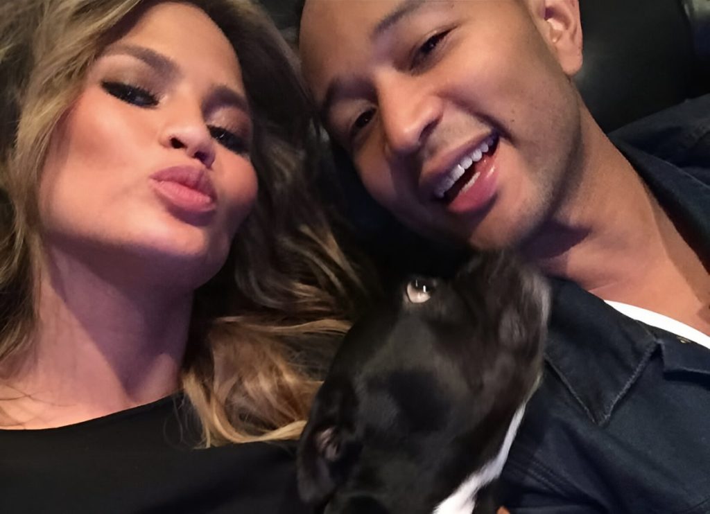 Chrissy Teigen and John Legend with their dog, Penny.