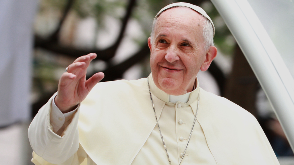 Pope Francis waves to thousands of followers as he arrives at the Manila Cathedral on January 16, 2015 in Manila, Philippines.