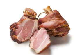 Appetizing golden smoked pork shank isolated on white background
