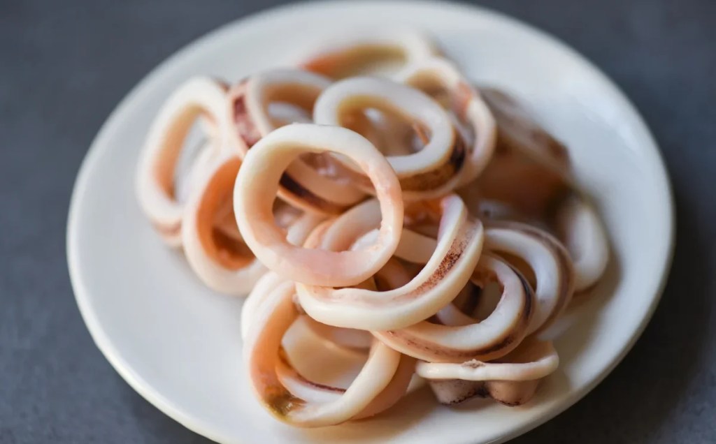 A closeup photo of plain, cooked calamari which dogs can eat safely.