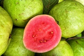 A closeup photo of a sliced guava, which dogs can eat safely in moderation.